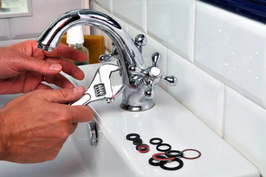 Plumber performing maintenance on a bathroom faucet in Sanford
