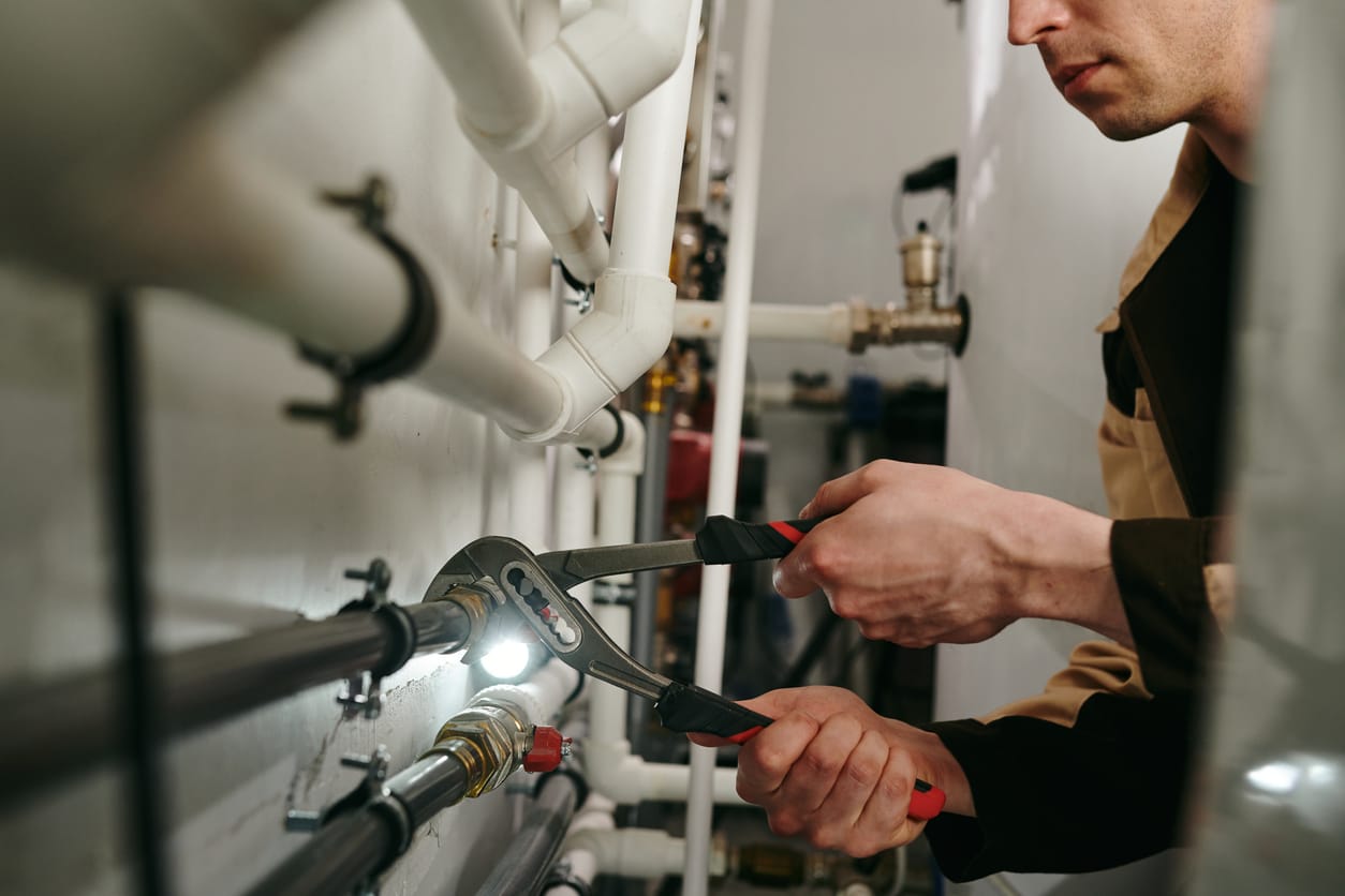 Plumbers maintaining commercial plumbing pipes in Sanford
