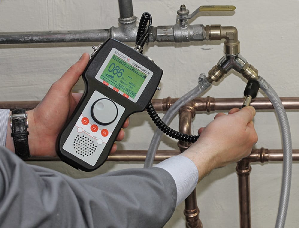 Plumber testing pipes with electronic leak detection equipment in Sanford