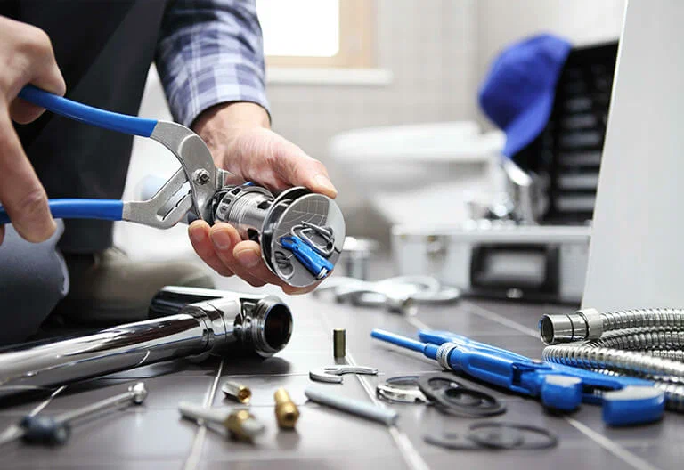 Technician repairing a plumbing fixture with professional tools in Sanford