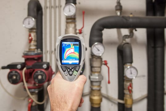 Plumber using a thermal imaging camera to inspect pipes in Sanford
