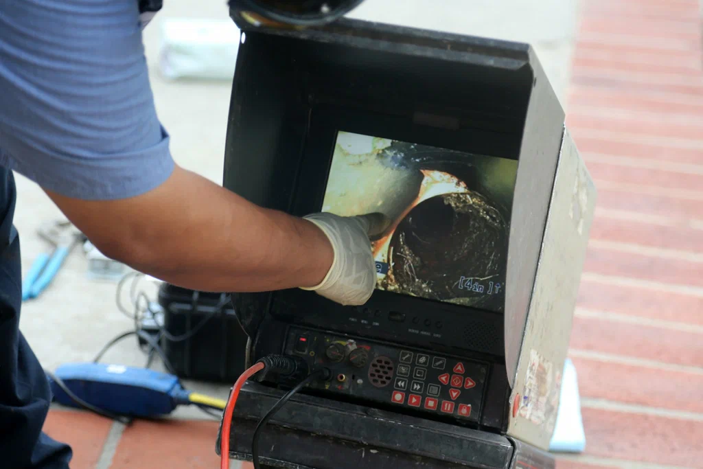 Technician viewing a drain inspection camera in Sanford