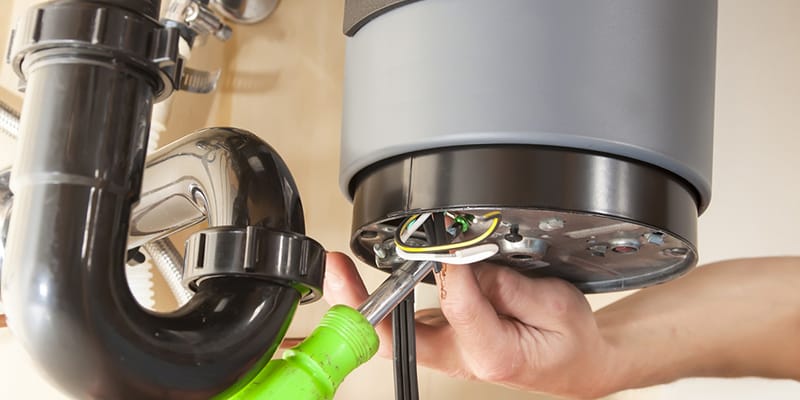 Technician repairing the heating element of a water heater in Sanford