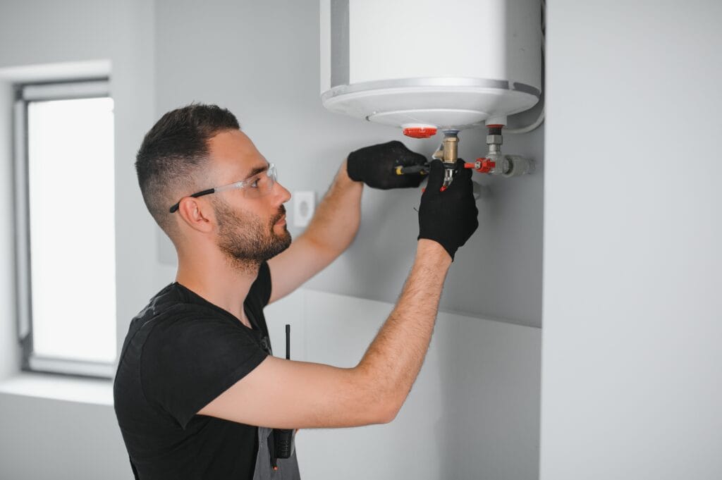 Technician performing water heater maintenance in Sanford