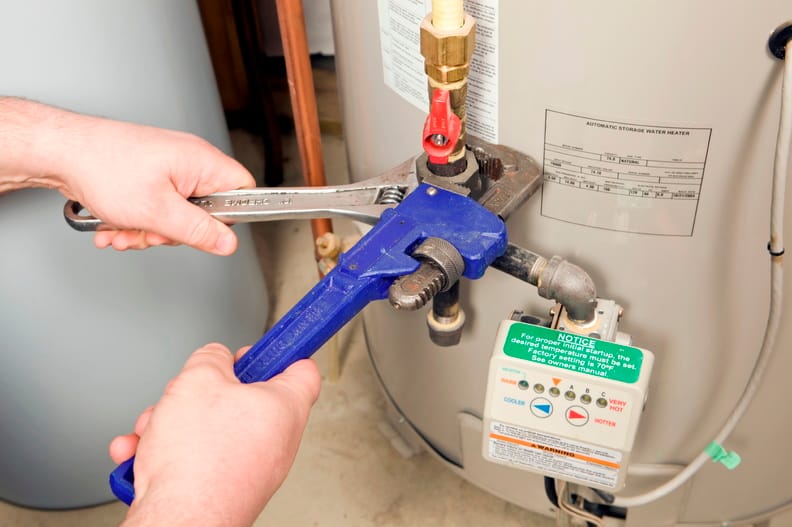 Plumber repairing a water heater valve in Sanford